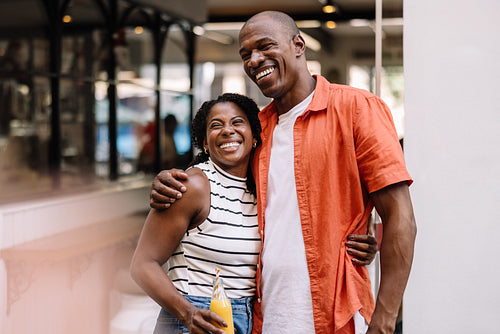 Happy couple sharing a fun moment outdoors, both smiling joyfully