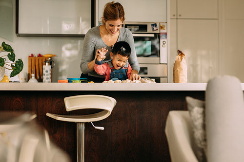 Happy young family having fun while making cookies