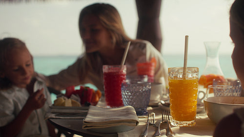 In-villa breakfast for a happy family enjoying their luxurious tropical island resort vacation