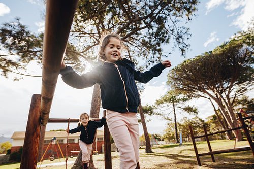 Twin girls playing at the public park