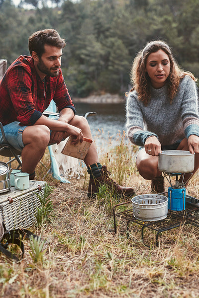Young couple camping by the lake