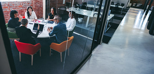 Female supervisor briefing her team in an office