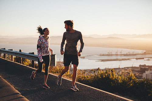 Two people running on a country road in morning