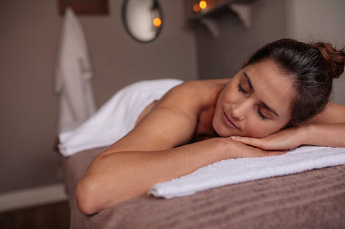 Woman relaxing on spa table in a wellness center