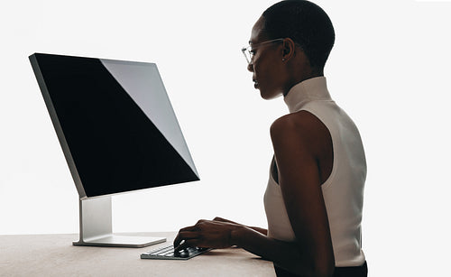 Young professional working on a computer in a modern minimalistic workspace