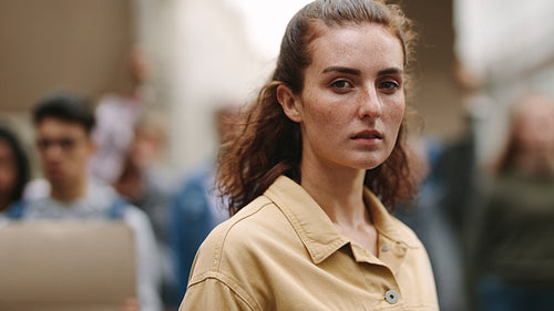 Woman protesting with group of rebellions