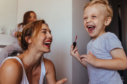Little boy playing with his mothers makeup
