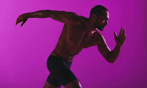 Fit athlete running bare chested