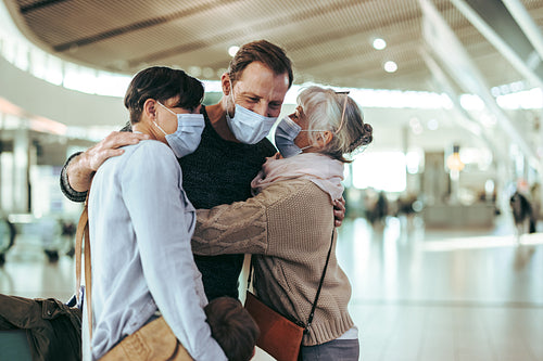 Senior woman receiving her family at airport after flight arriva