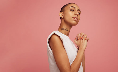 Confident woman with express yourself written on her neck.