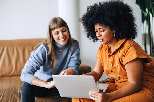Businesswomen having a discussion while using a laptop in an office