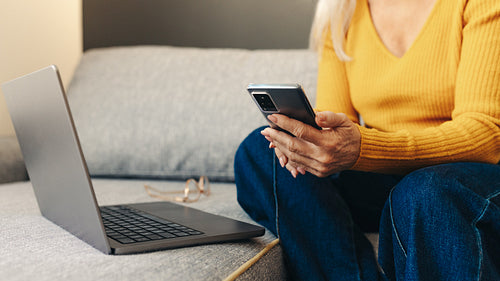Woman using technology to stay connected from her home office