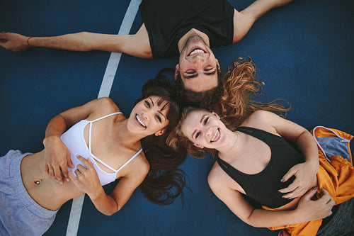Friends lying down no basketball court