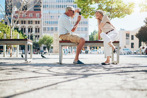 Mature couple photographing each other