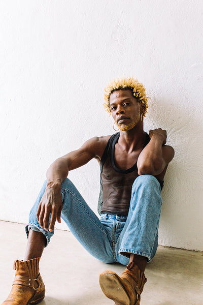 Nonconforming man sitting alone in a studio