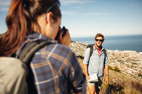 Young woman taking photo for her boyfriend