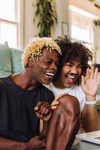 Male lovers video calling their friends at home