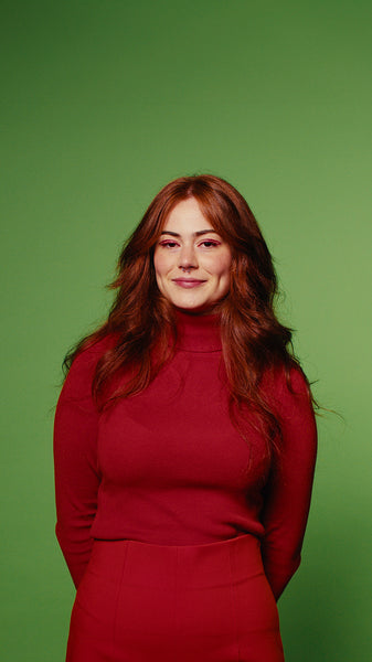 Smiling woman in red on green screen background