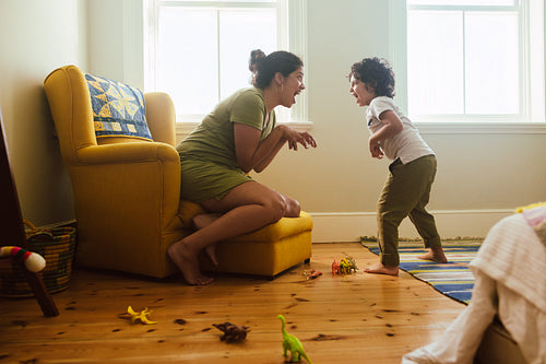 Mother and son imitating a dinosaur at home