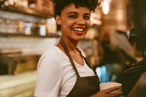 Female cafe worker preparing coffee