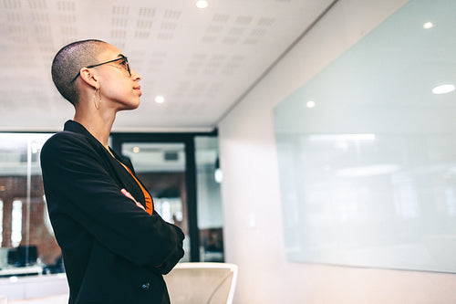 Young entrepreneur standing with her arms crossed in an office