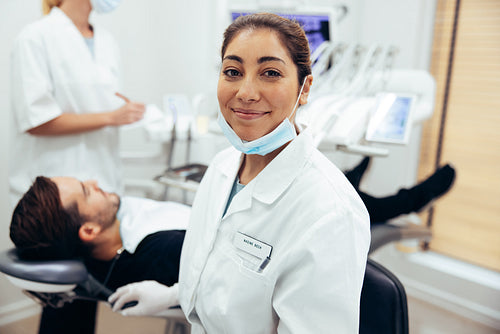 Happy female dentist in her clinic