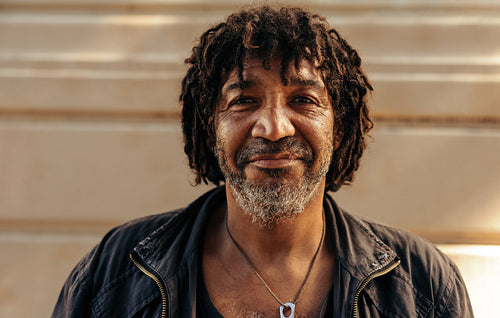 Cheerful homeless man looking at the camera