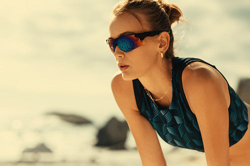 Professional female athlete relaxing on beach during pro volleyball tournament