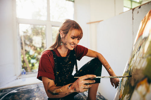 Professional painter working on canvas art