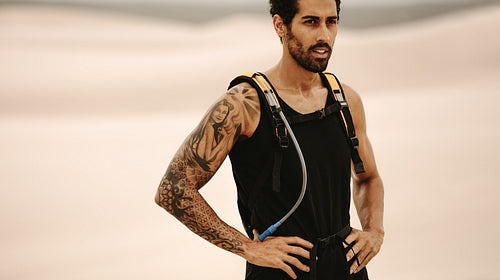 Man taking rest after workout in desert