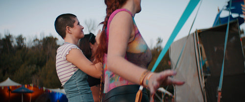 Happy young girls dancing at a music festival
