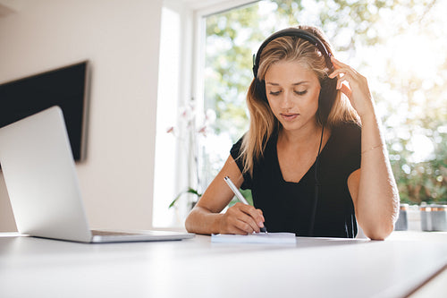 Woman studying in kitchen