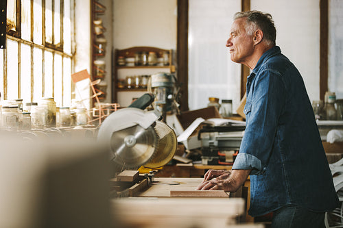 Thoughtful male carpenter in his workshop