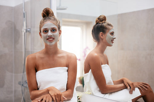 Beautiful young woman with facial mask