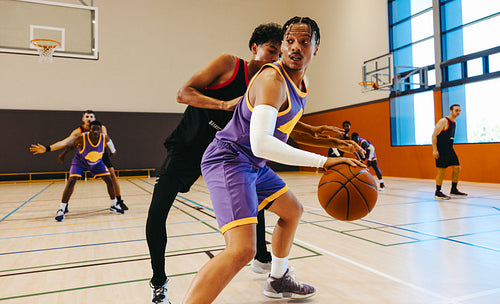 Players competing on indoor basketball court