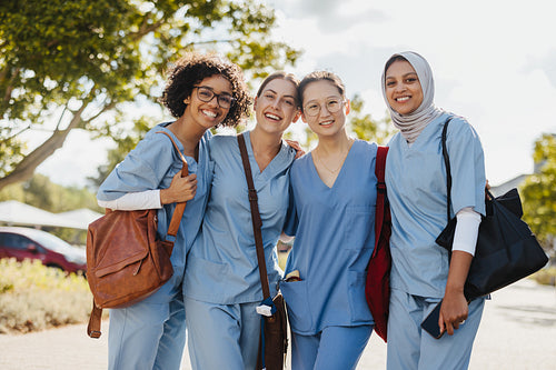 Portrait of female student doctors smiling happily in medical scrubs