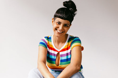 Queer woman celebrating gay pride in a studio