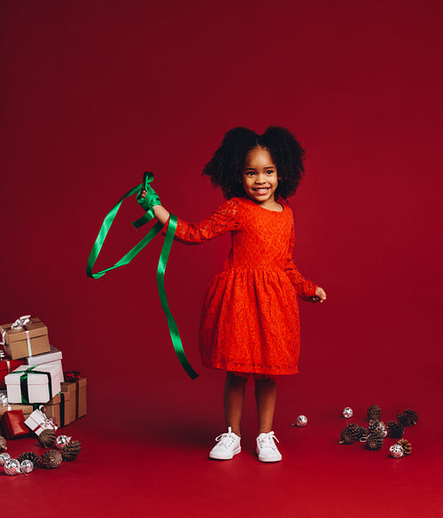 Afro american kid playing with a ribbon