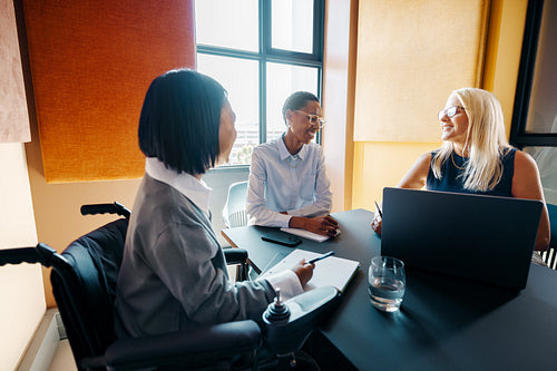 Team members engaged in a meeting in a modern office workspace