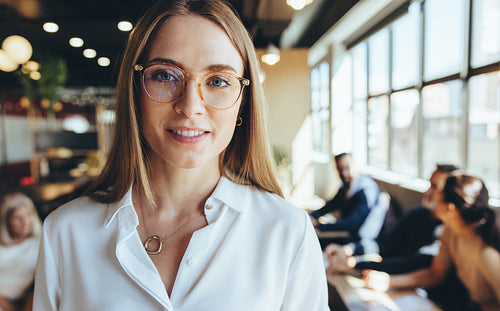 Businesswoman smiling at the camera in a co-working space
