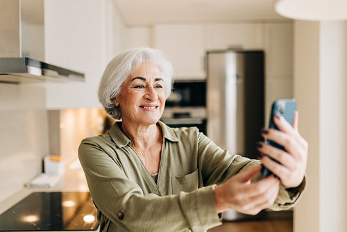 Elderly woman taking a video call on her smartphone
