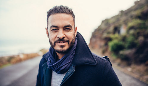 Handsome young man standing on road