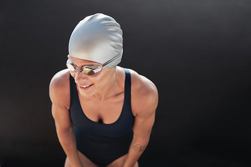 Female swimmer on black background