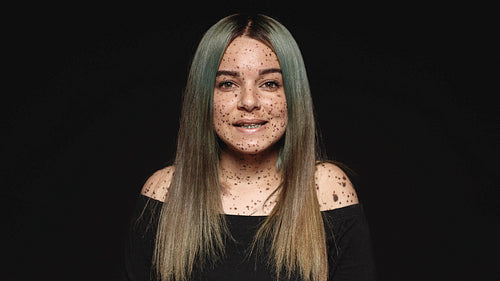 Portrait of a woman with freckles on body