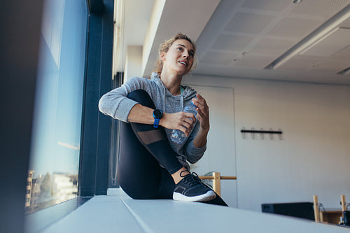 Fitness woman sitting in a pilates training gym