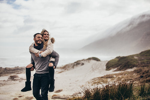 Couple enjoying winter holidays at the seashore
