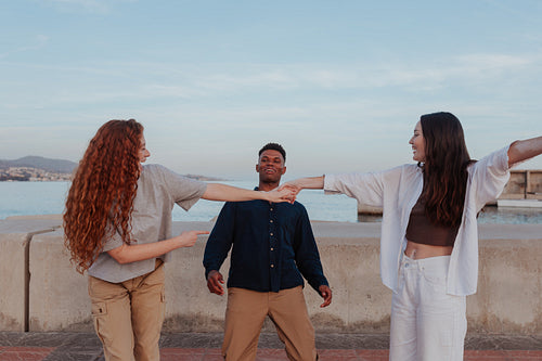 Two girlfriends dancing together outdoors