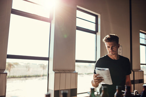 Brewer supervising the process of beer manufacturing on brewery factory
