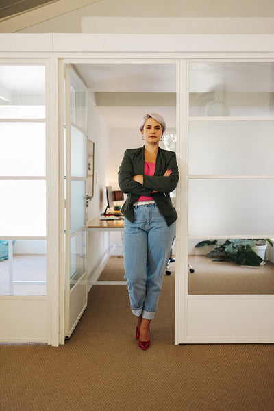 Confident businesswoman standing with her arms crossed
