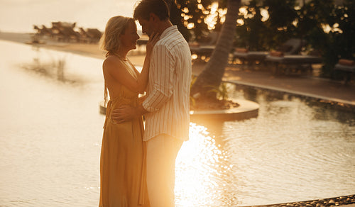 Romantic couple embracing at sunset